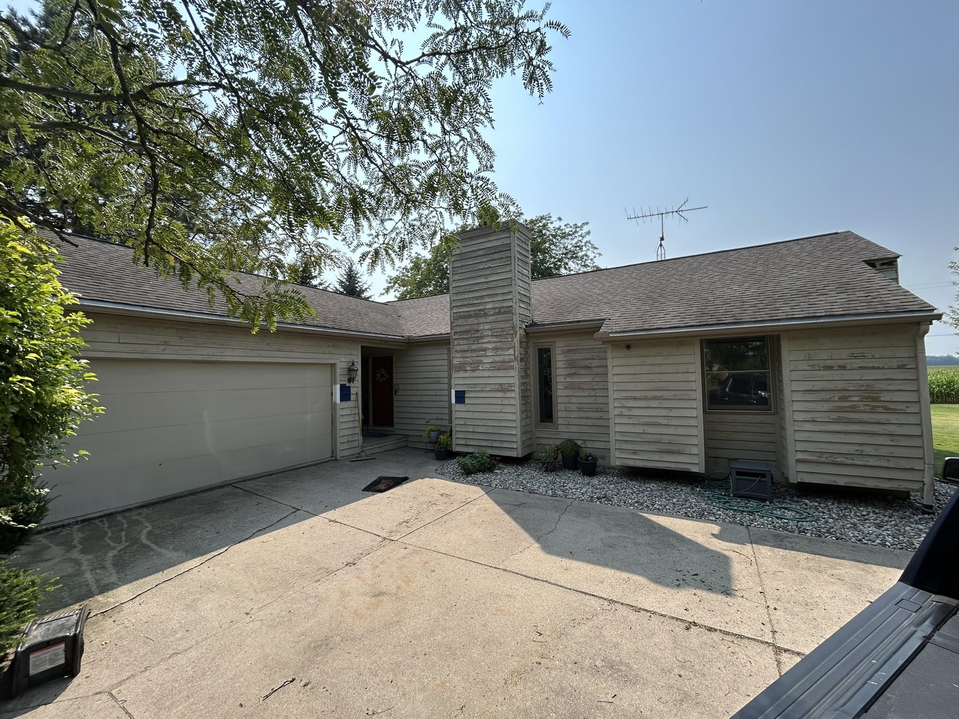 Before: wood lap siding with bare, peeling paint