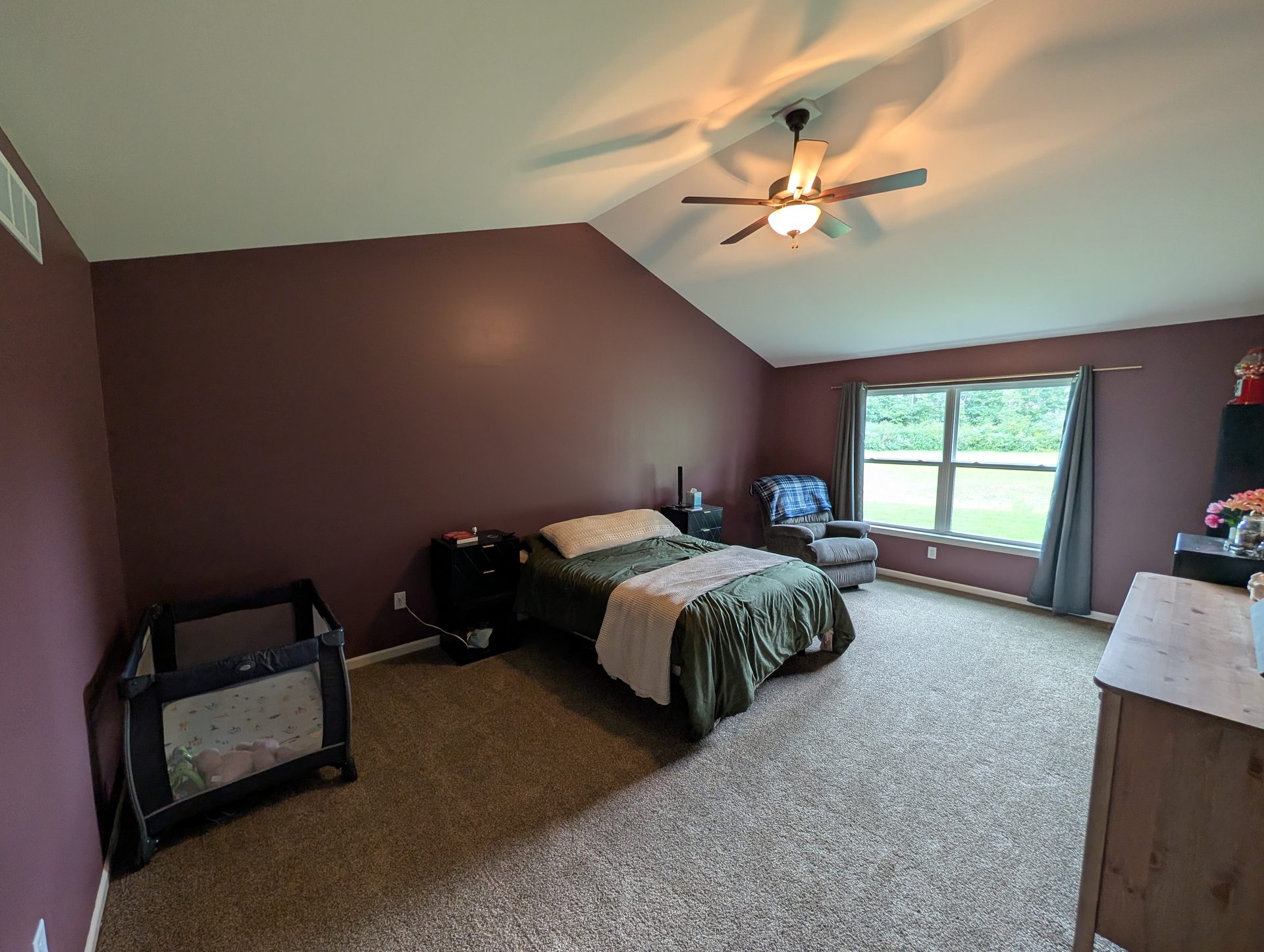 Vaulted ceiling edge where a pale ceiling meets plum walls